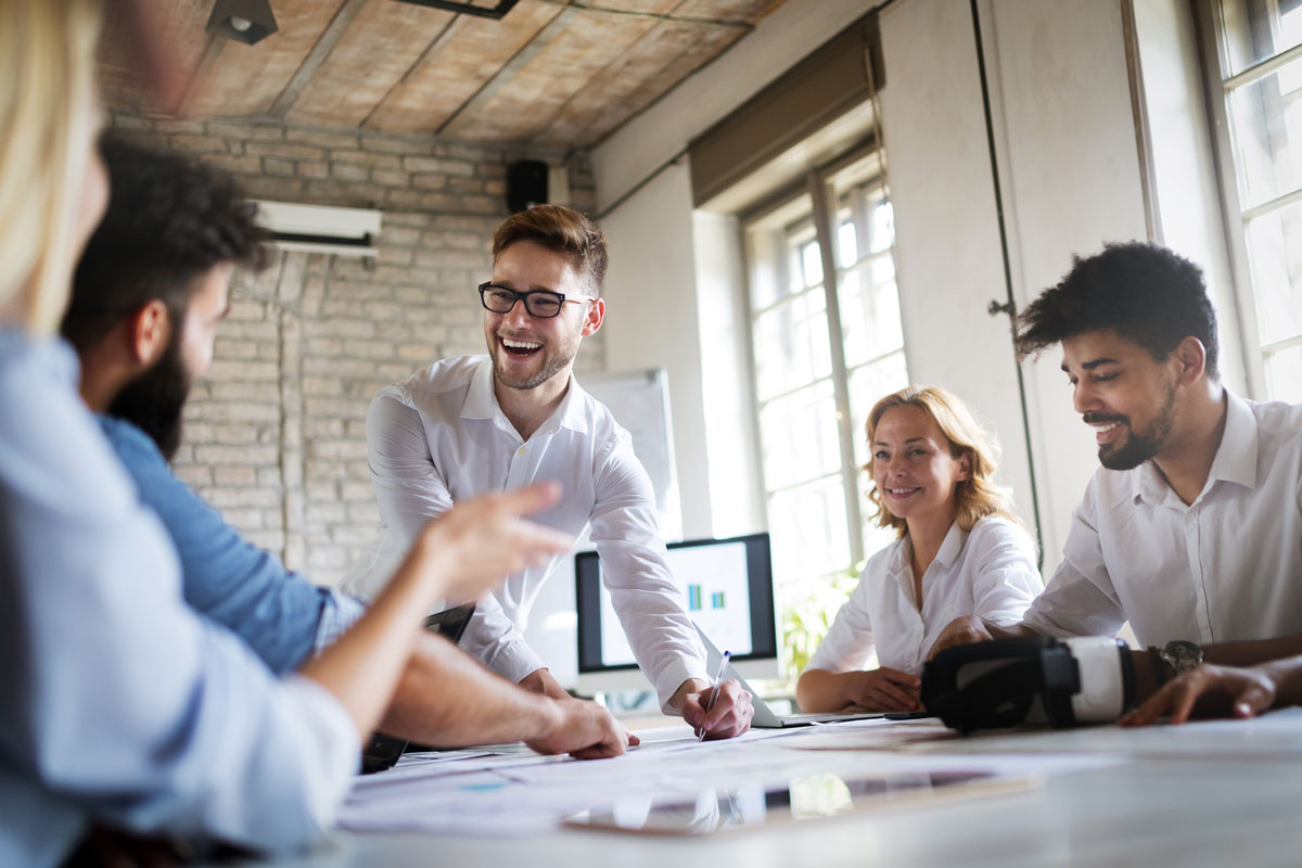 People sit around a boardroom table discussing content marketing.