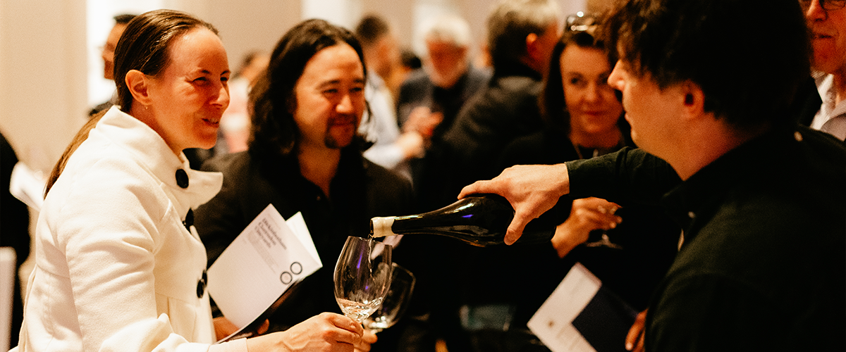 Wine being poured for a woman at an event