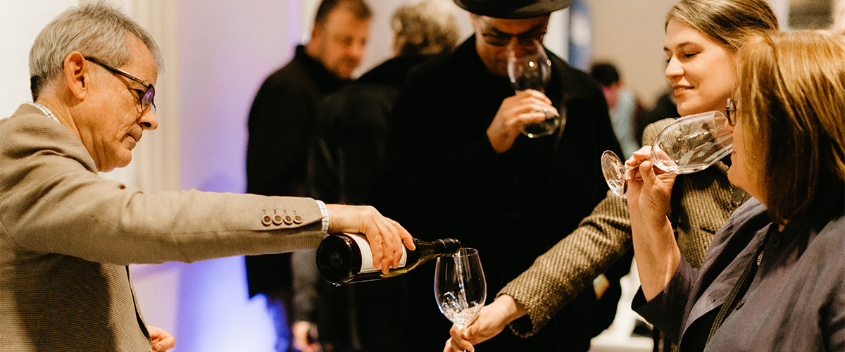 Wine being poured for a woman at an event