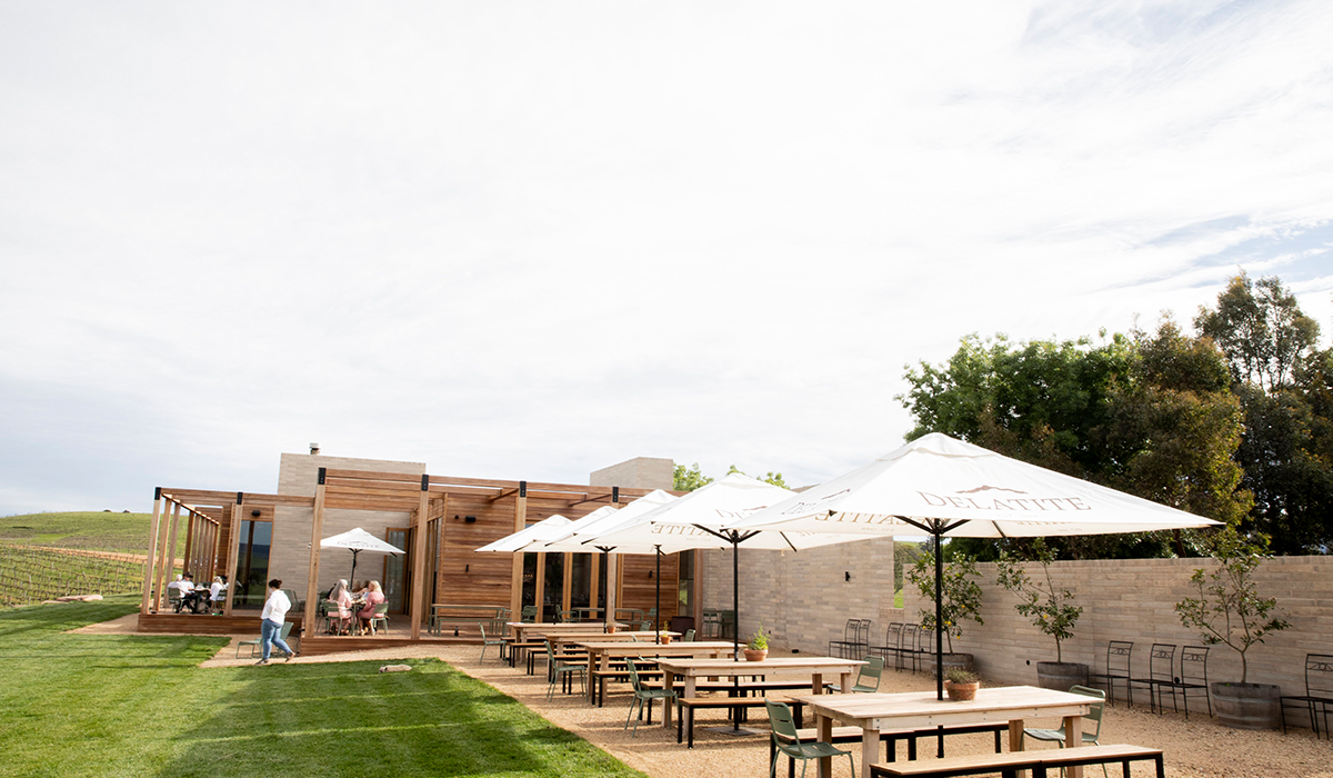 Delatite cellar door outside view with umbrellas and tables