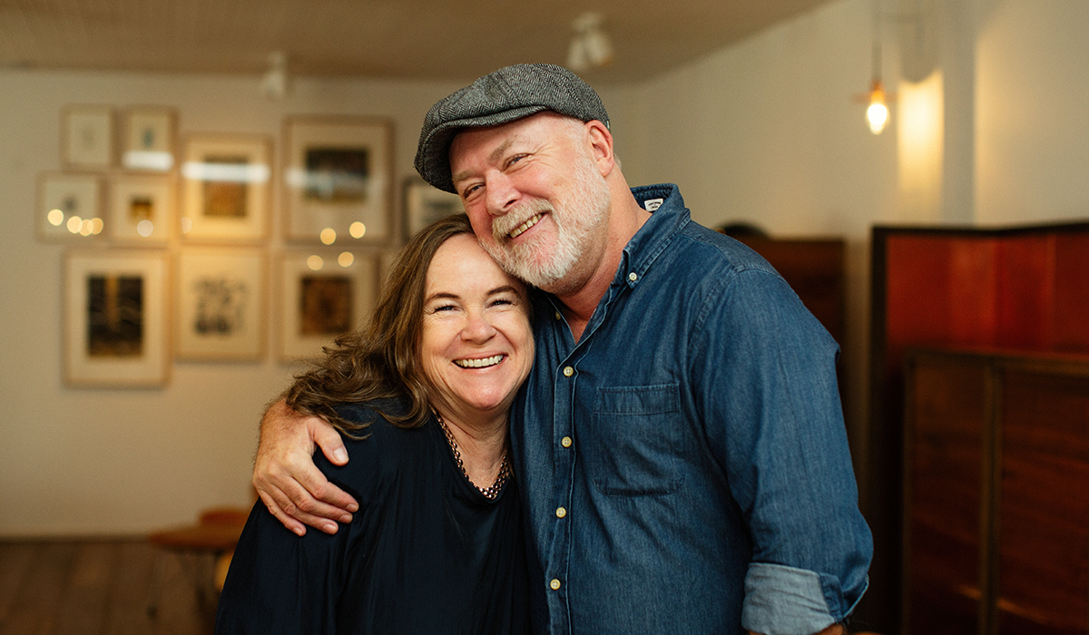 Jane Faulkner and Dave Brookes smiling. Dave has his arm around Jane.