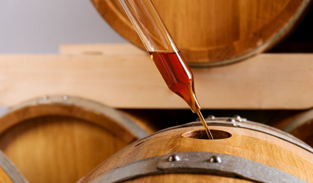 whisky being poured into a barrel