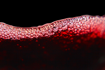 Close up of red wine on a black background