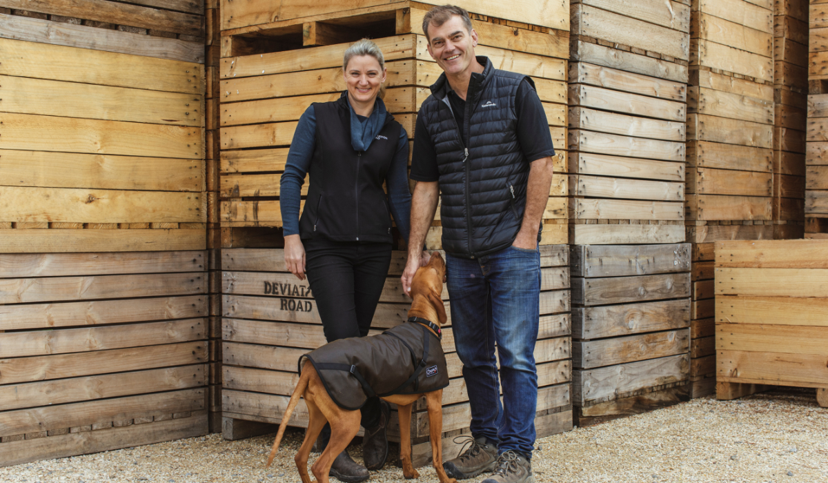 Kate and Hamish Laurie from Deviation Road pose with their dog