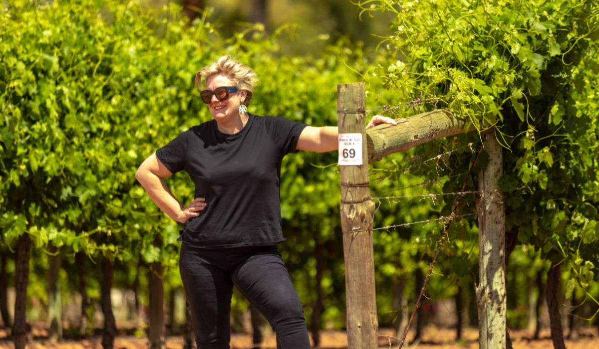 Kim Chalmers standing in her vineyard