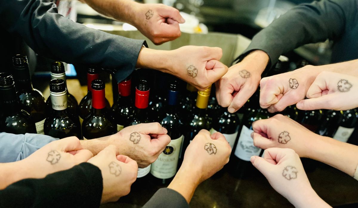 Hands showing cabernet leaf stamps
