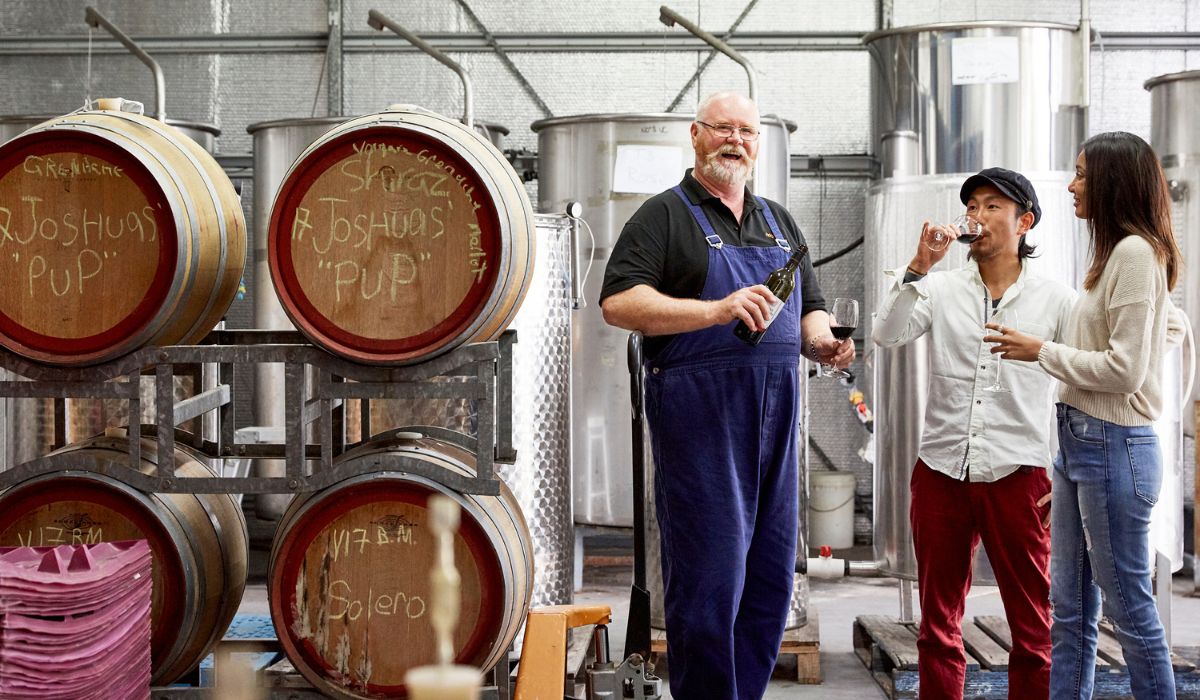 Winemaker pouring wine at Ridgemill Estate in the Grantite Belt.