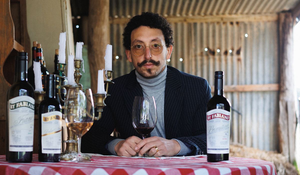 Fabiano Minchella sits at a table with his wines