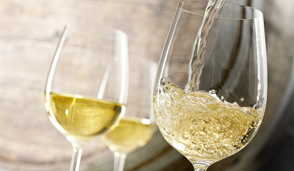 White wine pouring into a glass