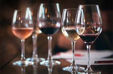 Different wines lined up in glasses