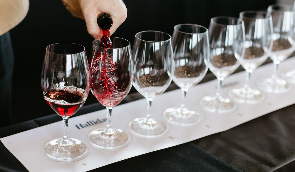 Red wine being poured into glasses