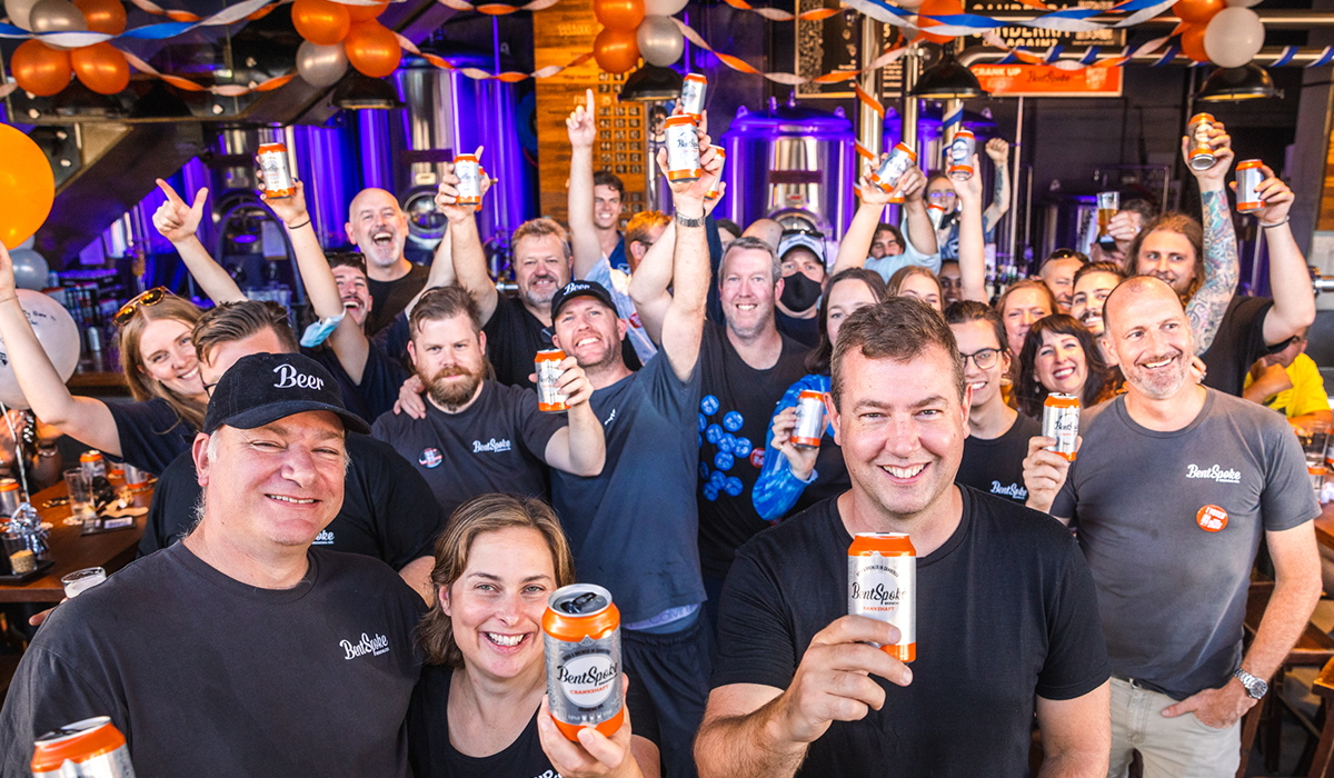 The BentSpoke team celebrating holding cans of Crankshaft