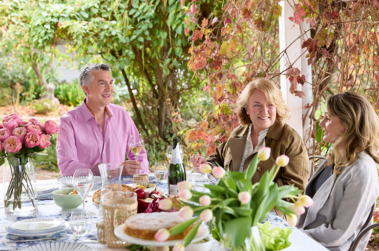 People sharing Champagne at dining table