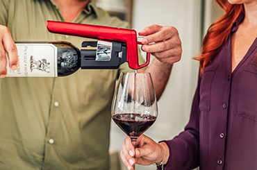 The Coravin Model Six dispensing red wine into a glass