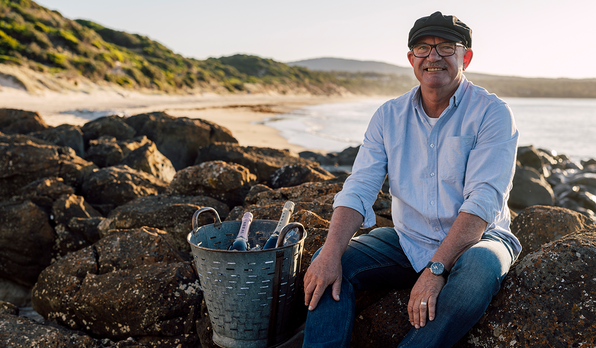 Ed Carr with wine on beach
