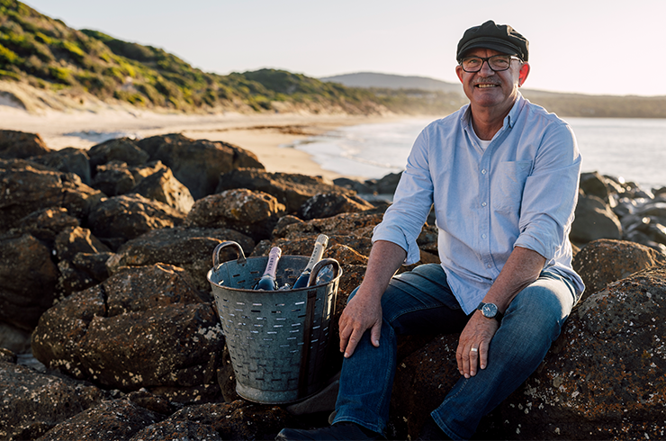Ed Carr with wine on beach
