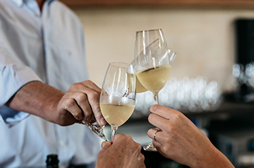 Three glasses of Gilbert sparkling wine being cheersed 