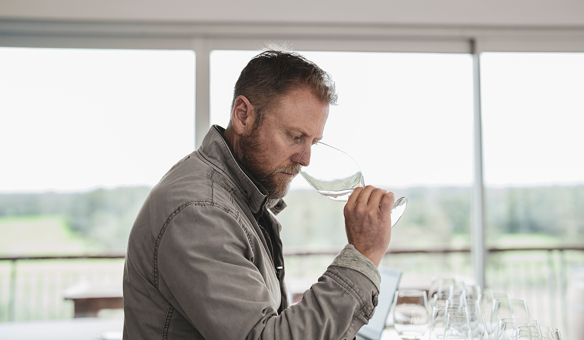 Adam Wadewitz smelling a glass of chardonnay