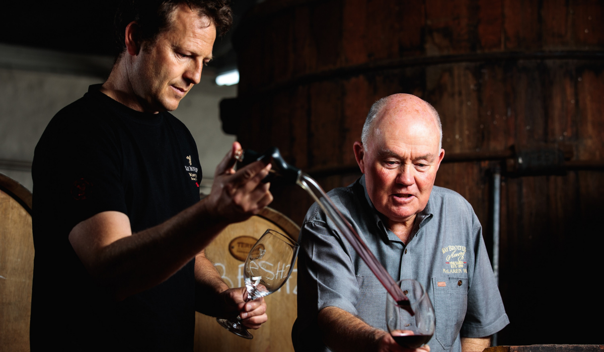 Two winemakers taste wine