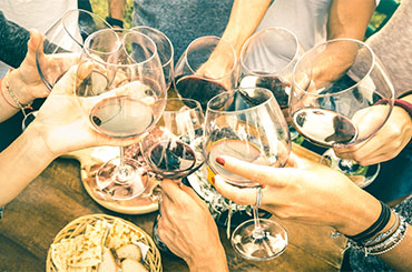 People clinking wine glasses