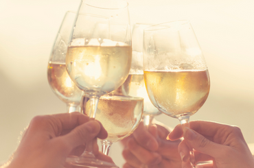 Five wine glasses clinking cheers