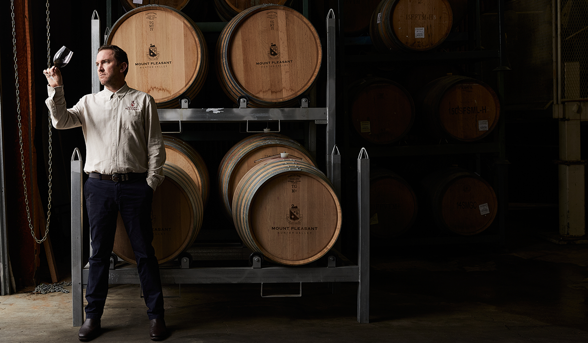 Adrian Sparks looking at a wine in the barrel room