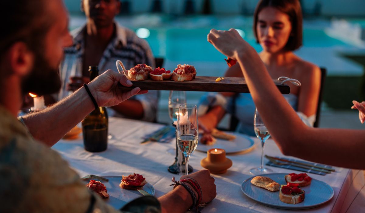Outdoor dinner party with sparkling wine