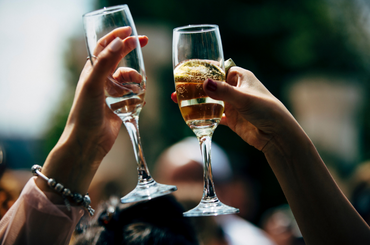 Two champagne glasses clinking