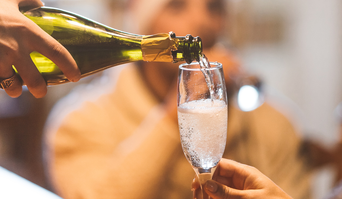 Sparkling wine being poured into a glass. 