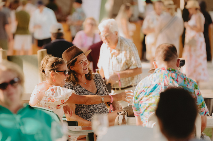 People socialising outside drinking wine 