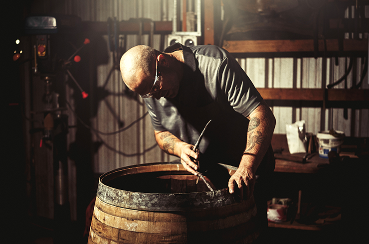 A man working on a wine cask