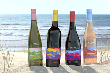 Wynns Reframed four bottles on the sand with the beach in the background