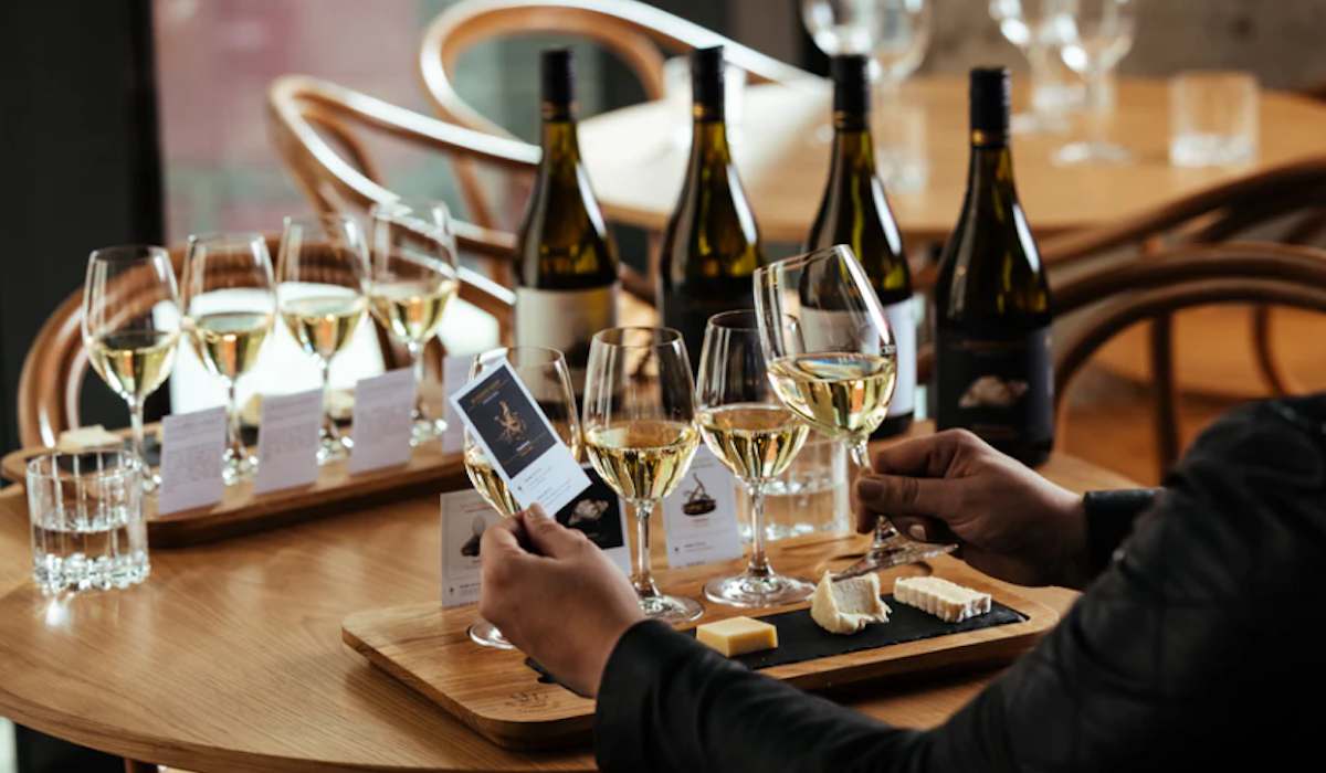 a person tasting wine at a cellar door - handpicked wines