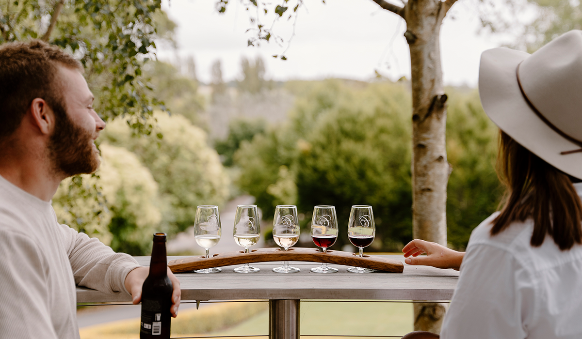 Two people tasting a wine flight