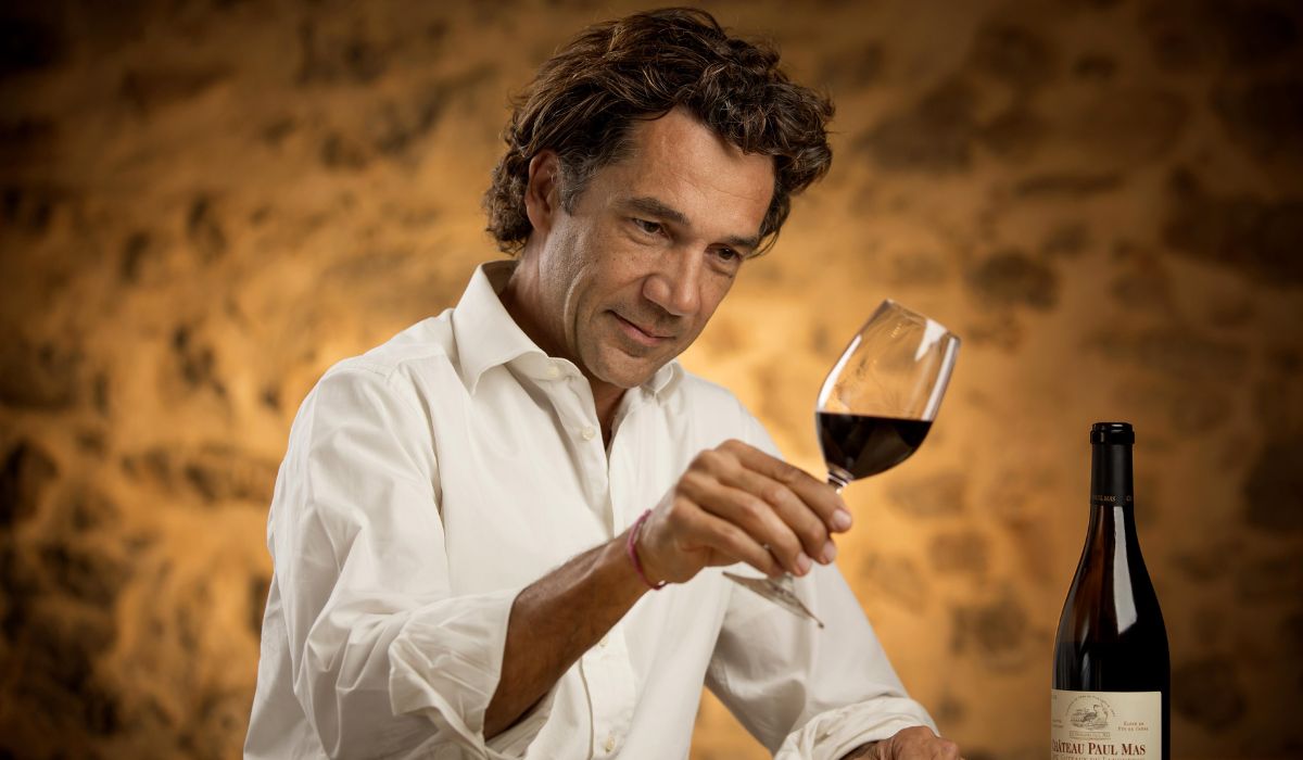 Winemaker Jean-Claude Mas assesses a glass of red wine