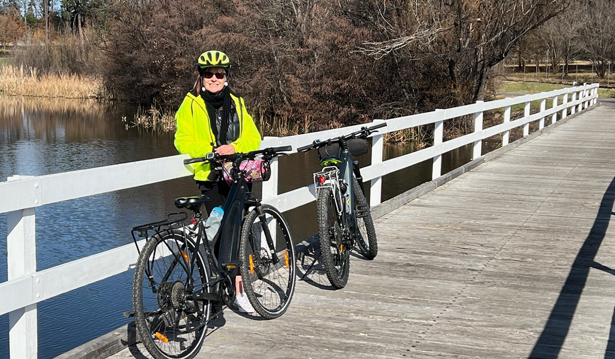 Jeni Port standing with her bike