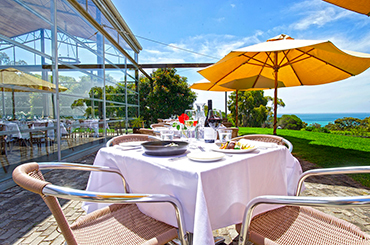 Outdoor table with a view of the ocean | Terindah Estate winery