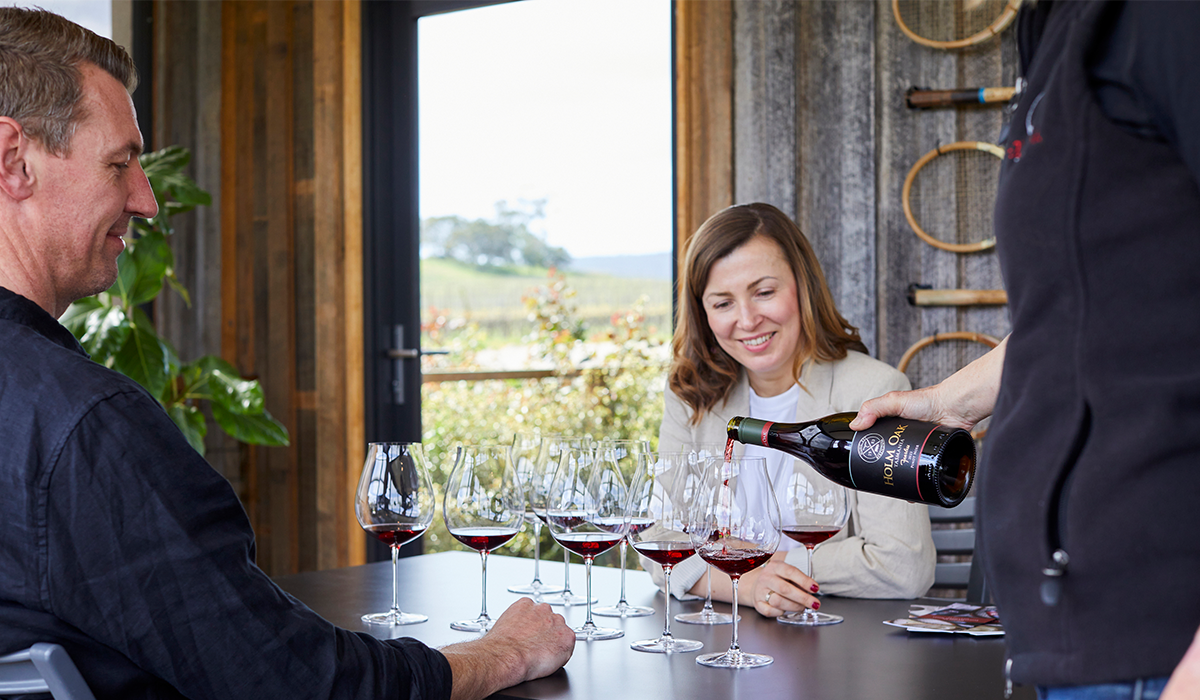 Couple doing wine tasting at cellar door