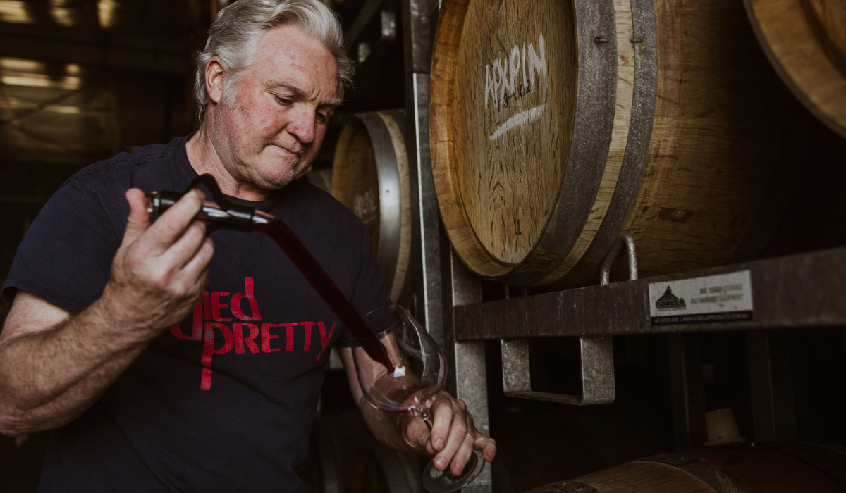 Oakridge winemaker David Bicknell uses a wine thief to sample wine from a barrel