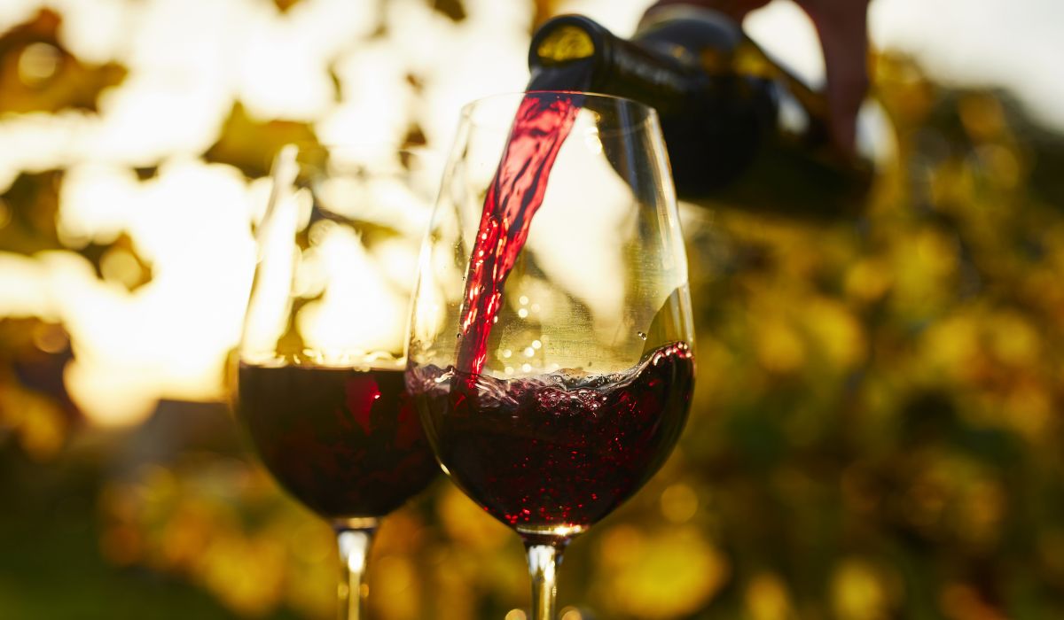 Red wine pouring into two glasses
