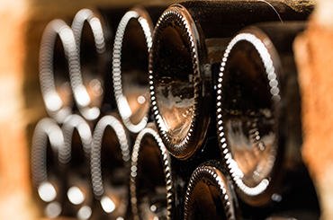 Wines bottles in the brick wall of a cellar