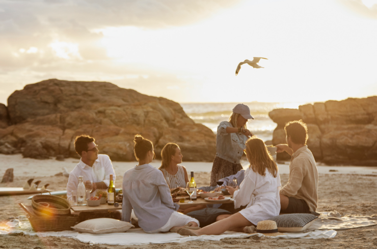 Group of people enjoying Cape Mentelle sauvignon blanc on the beach 