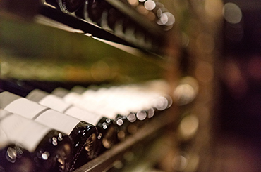 Out of focus row of bottles laying down on a shelf
