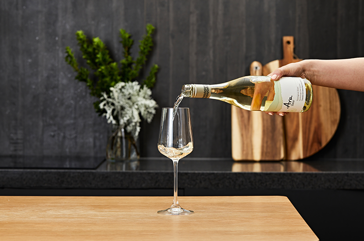 A glass of Ara Zero Sauvignon Blanc being poured
