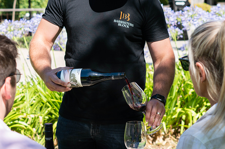 Man pouring red wine