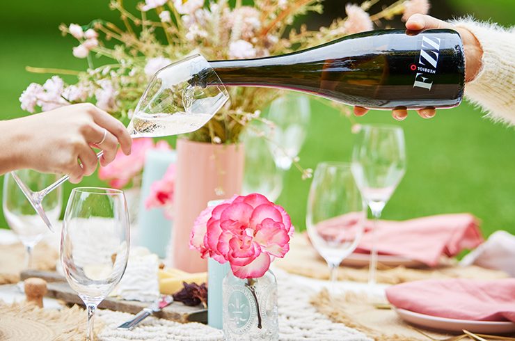 Sparkling wine being poured at picnic