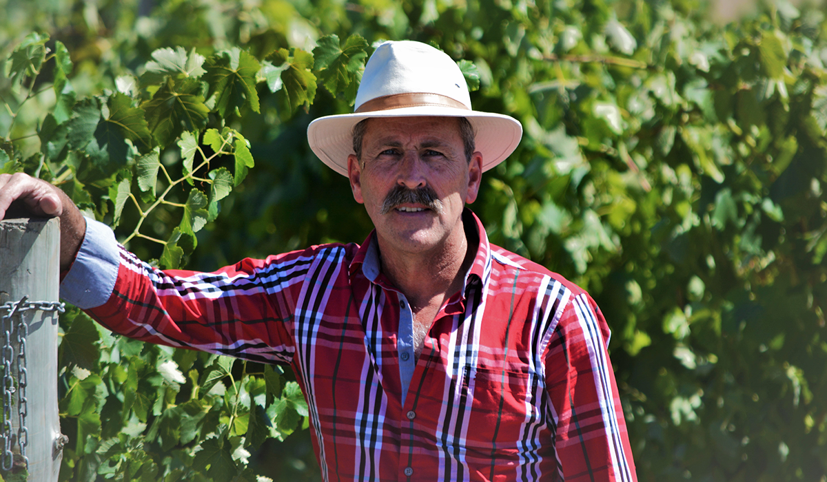 Leigh Clarnette with the vineyard behind him