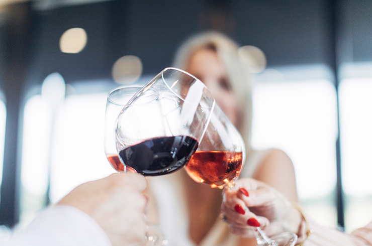 Three glasses being raised