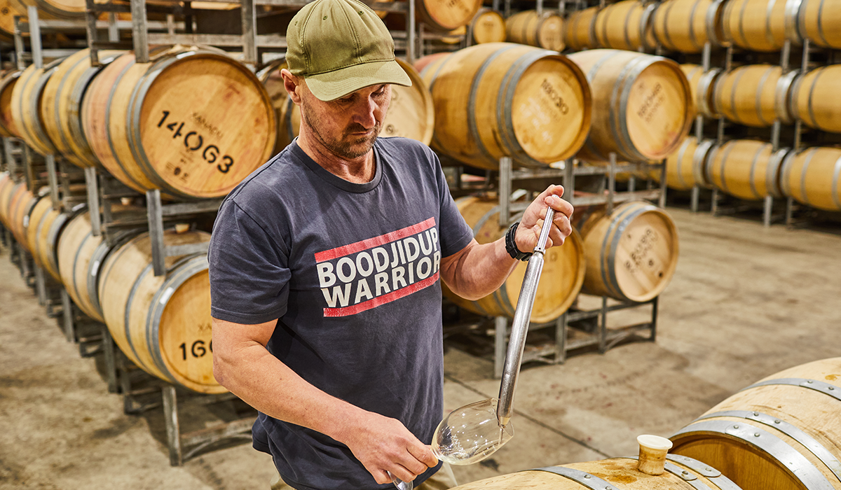 Glenn in the barrel room wearing a Boodjidup Warrior tshirt