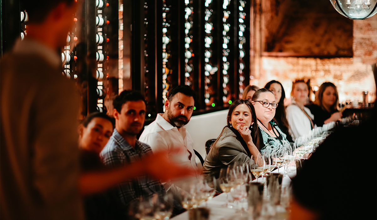 Guests attending a masterclass event with a winemaker.